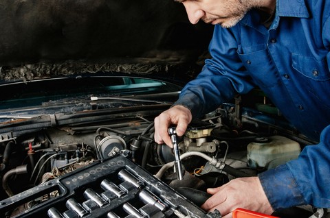 Close-up of a car diagnostic tool being plugged into an OBD-II port