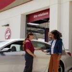 Woman and Jiffy Lube technician reviewing car diagnostic test results