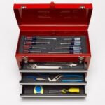 A well-stocked toolbox, but you only need a few essential tools to remove a car battery, like wrenches and pliers.