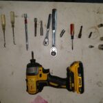 Various pry tools and socket wrenches used for car dashboard removal