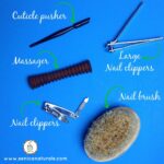 Essential foot care tools including nail clippers, cuticle pusher, and nail brush for a home pedicure.