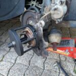 Car bearing tool mounted for removal of the old bearing assembly