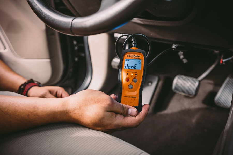 Locating the OBD2 port under the dashboard, driver's side