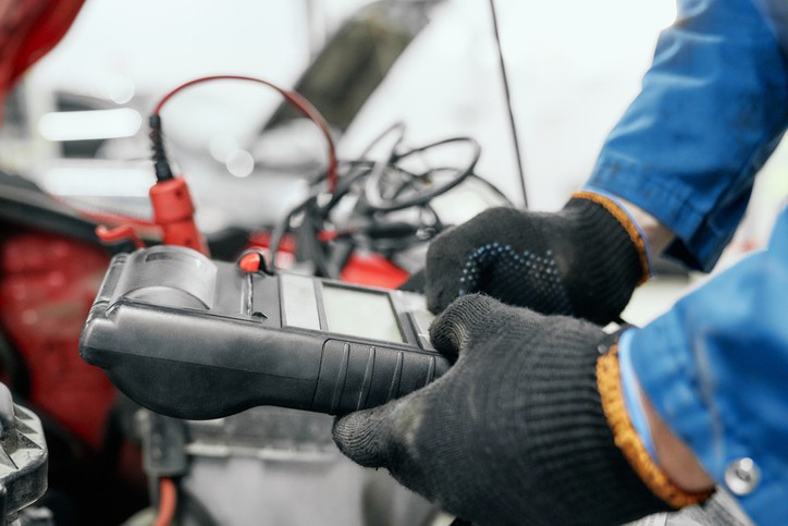 An OBD-II scanner being used to diagnose a vehicle's system