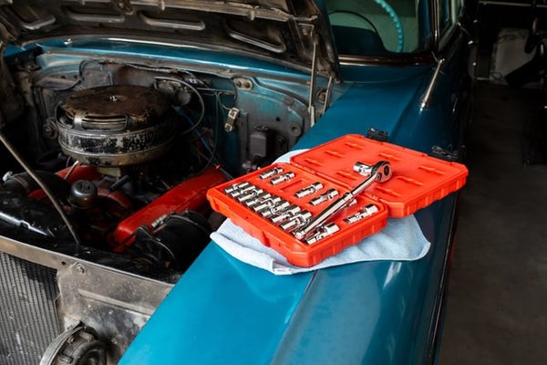 Various sockets and drivers in a socket set, essential for car tune ups